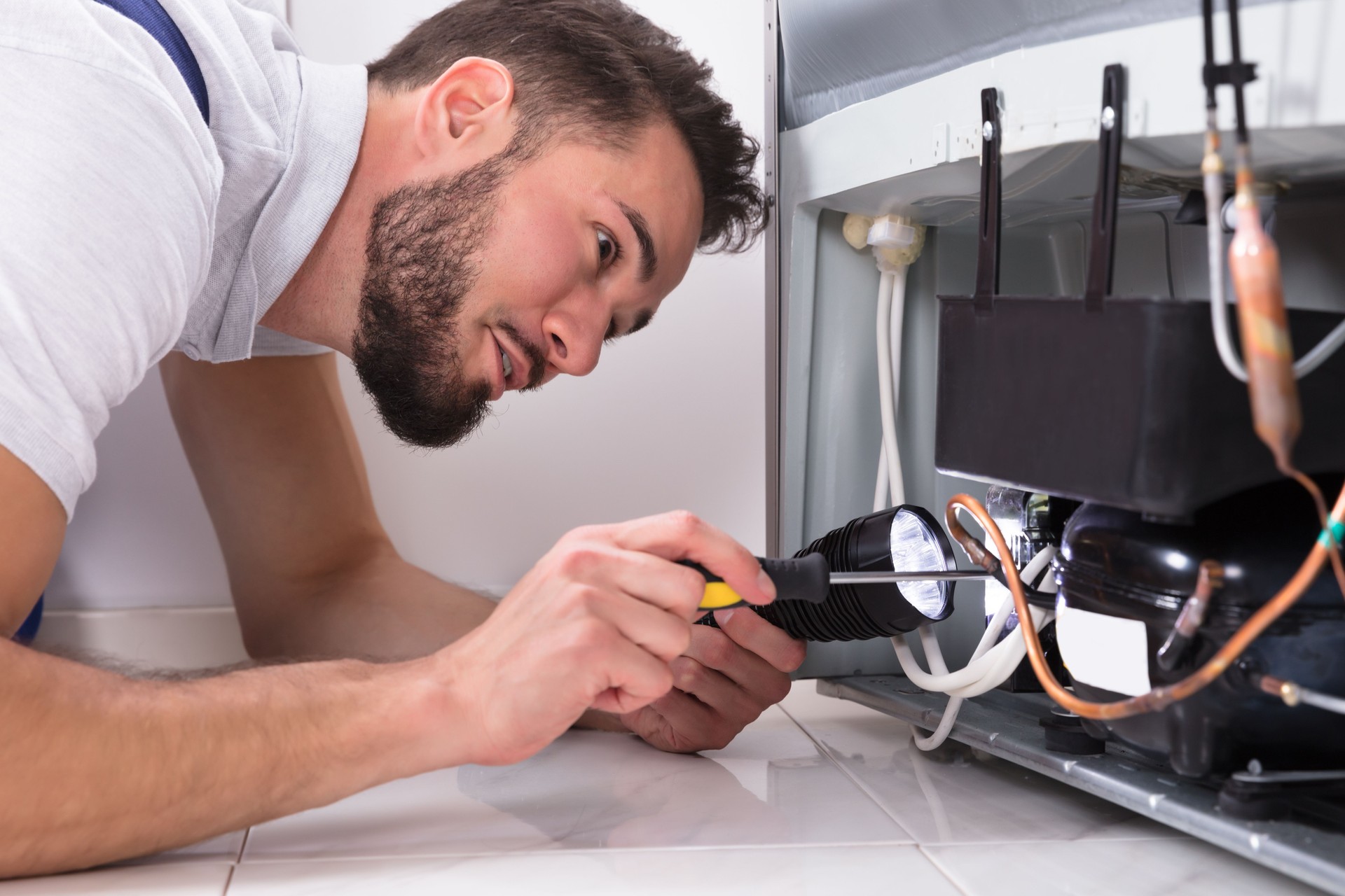Technician Repairing Refrigerator